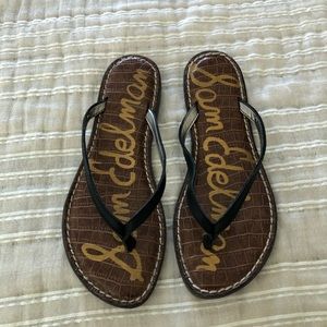 Black leather flip flops